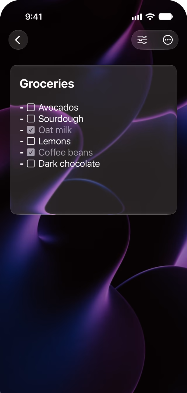 A Glassnote grocery list. Oat milk and coffee beans are checked and dimmed. Avocados, sourdough, lemons and dark chocolate are still open.