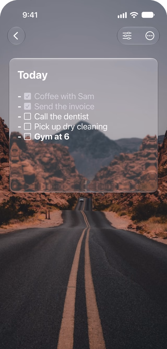 A Glassnote note called Today, a checklist with two items checked and dimmed, sitting as a pane of glass over a photo of a desert road.